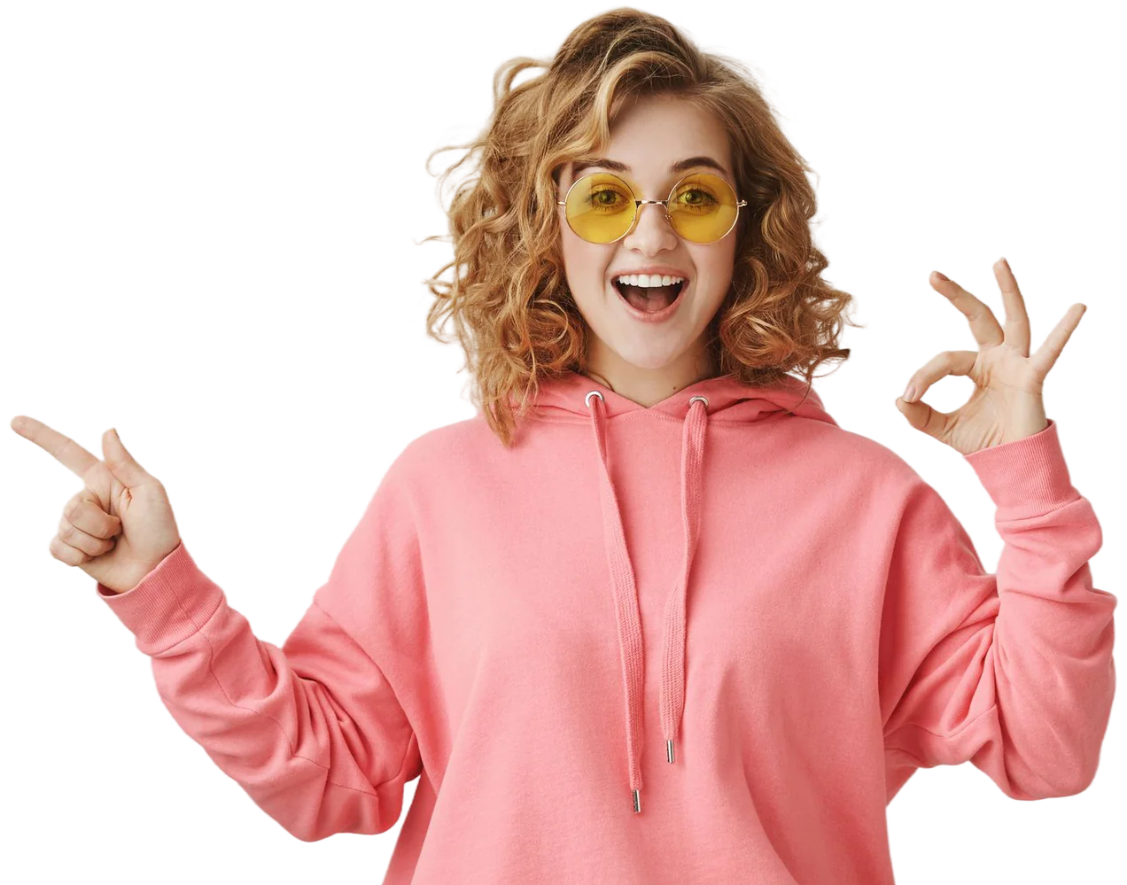Surprised young woman in a pink hoodie pointing to the side