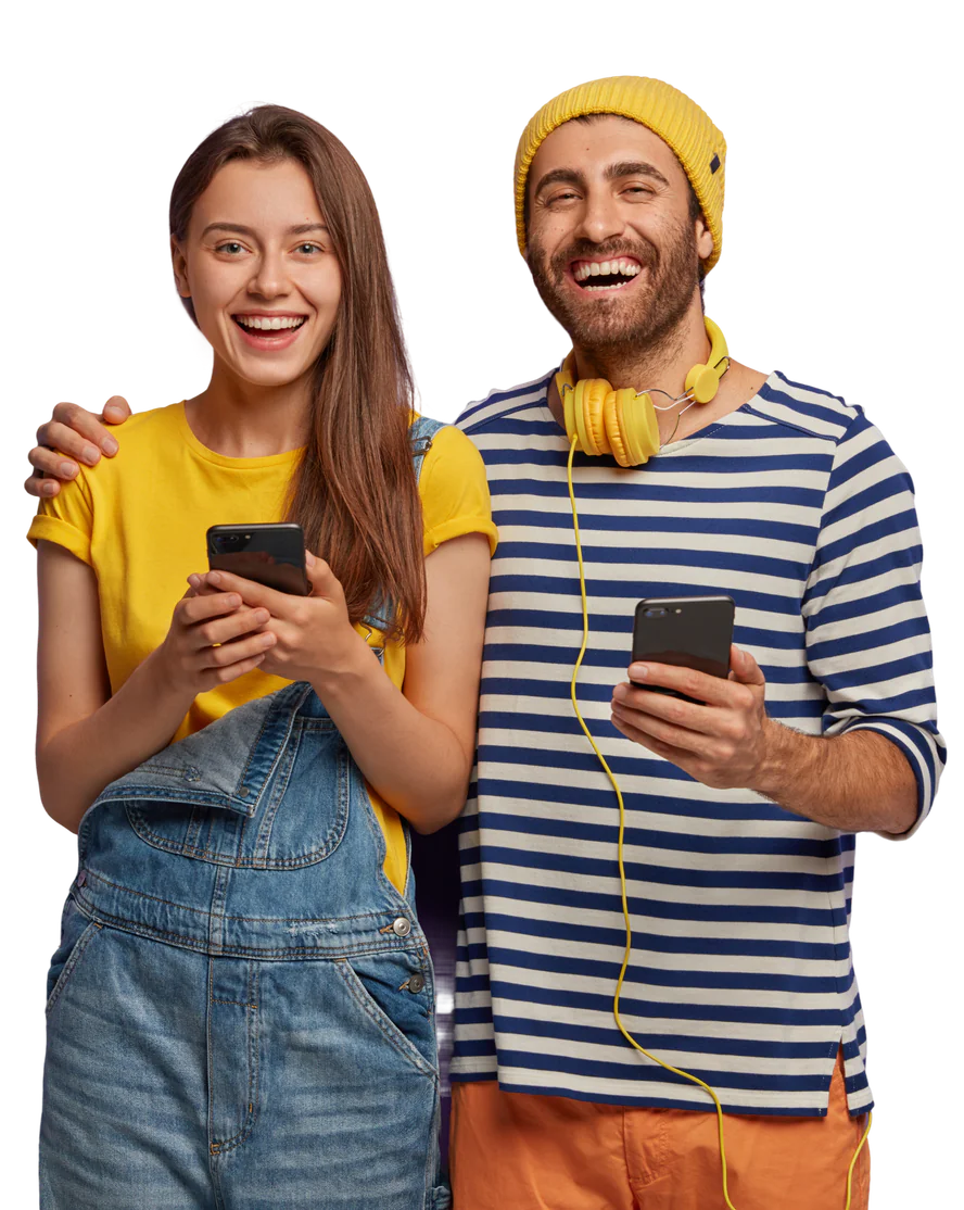 Happy young couple embracing, both holding phones