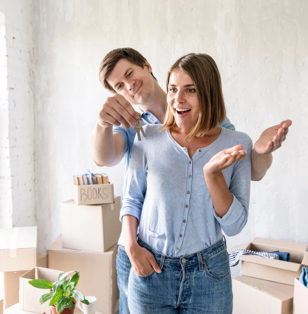 Young couple moving into a new home, holding up the keys